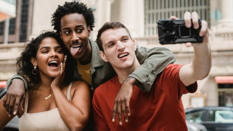 Group of friends laughing and having fun during a travel adventure, embodying the humor and joy of funny travel moments