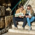 Happy travelers reading Gateway Travel reviews to plan their trip with confidence
