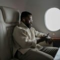 Traveler comfortably using a travel pillow on an airplane seat for neck support and restful flight experience