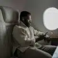 Traveler comfortably using a travel pillow on an airplane seat for neck support and restful flight experience