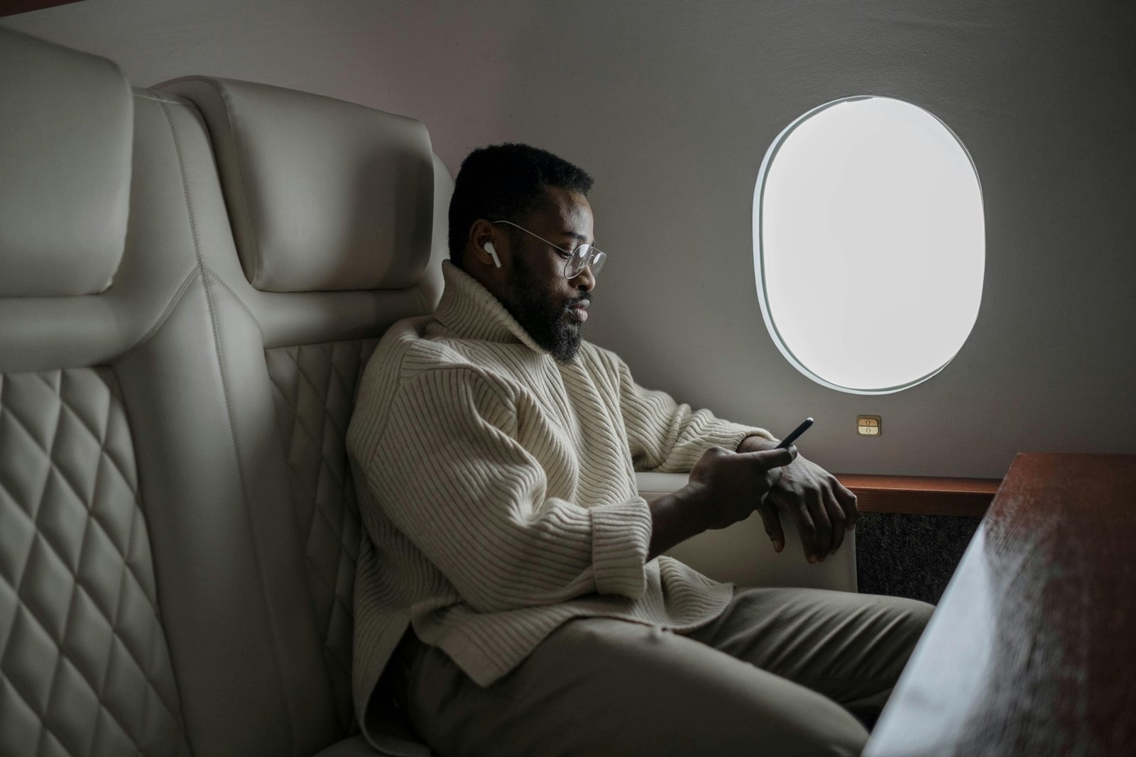 Traveler comfortably using a travel pillow on an airplane seat for neck support and restful flight experience