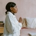 Traveler praying for safety and protection before embarking on a journey, symbolizing traveling mercies