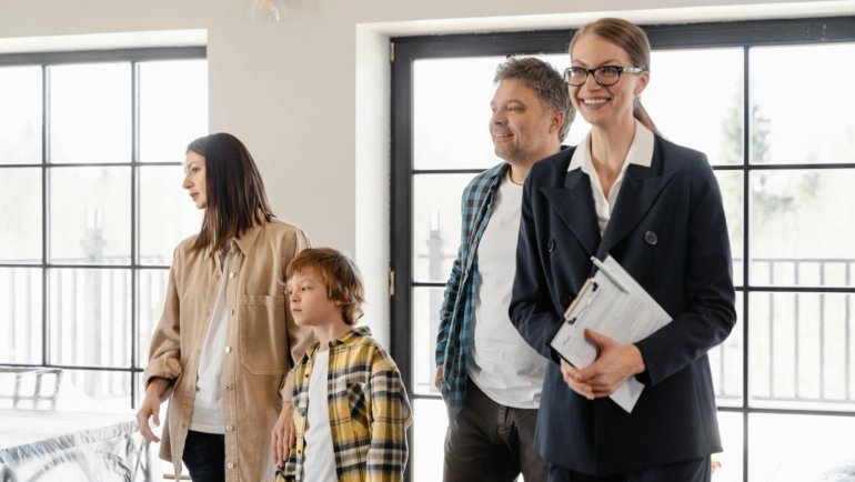 Travel agent helping family plan a magical Disney vacation with brochures and laptop