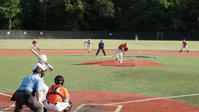 Youth baseball team competing in a travel tournament outdoors, representing Arkansas travel baseball competition and player development