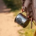 Travel mug with spill-proof lid keeping beverage hot and secure on the go