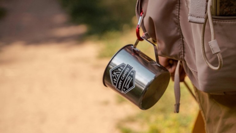 Travel mug with spill-proof lid keeping beverage hot and secure on the go
