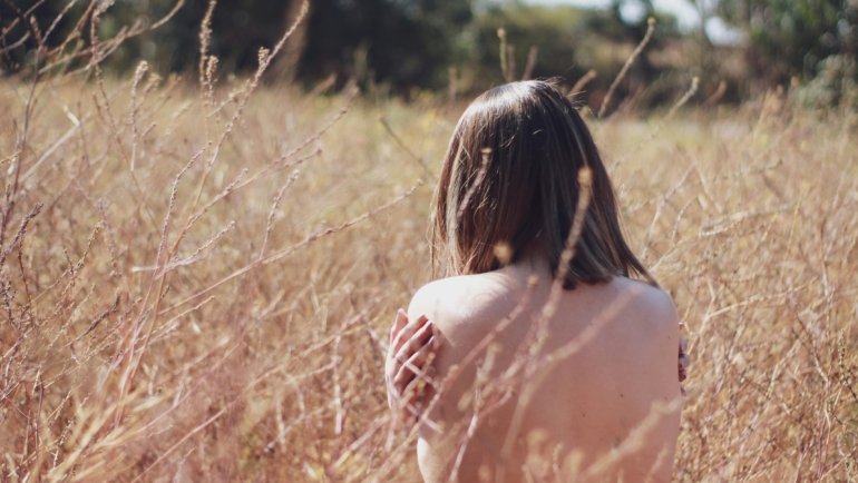 Person enjoying nude travel in nature embracing freedom and body positivity