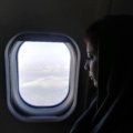 Muslim passenger praying on airplane for safety and spiritual protection during flight