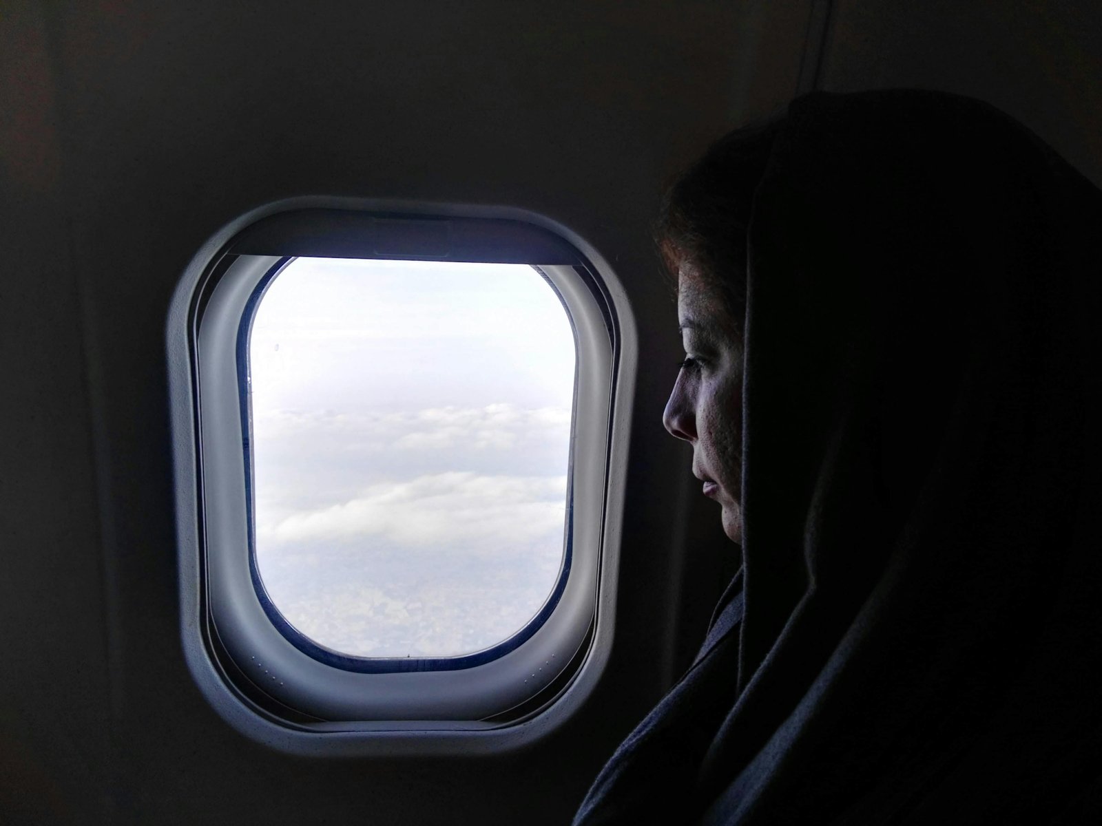 Muslim traveler praying for safety and protection during airplane flight
