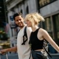 Friendly travel companion walking through a city street providing safety and local guidance for a traveler