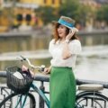 Woman wearing a lightweight travel skirt walking outdoors in city and nature settings, showcasing versatile and comfortable travel clothing
