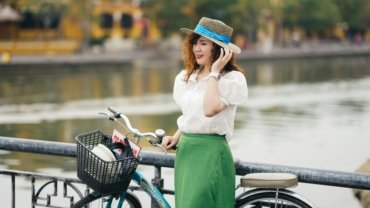 Woman wearing a lightweight travel skirt walking outdoors in city and nature settings, showcasing versatile and comfortable travel clothing