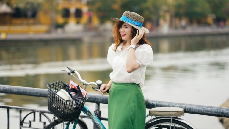 Woman wearing a lightweight travel skirt walking outdoors in city and nature settings, showcasing versatile and comfortable travel clothing