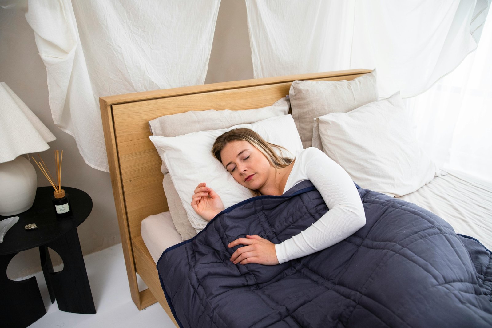 Traveler resting comfortably wrapped in a cozy weighted blanket during travel, promoting relaxation and better sleep on the road