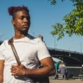 Traveler wearing a lightweight crossbody travel bag walking in the city, showcasing comfort, secure travel gear, and hands-free convenience