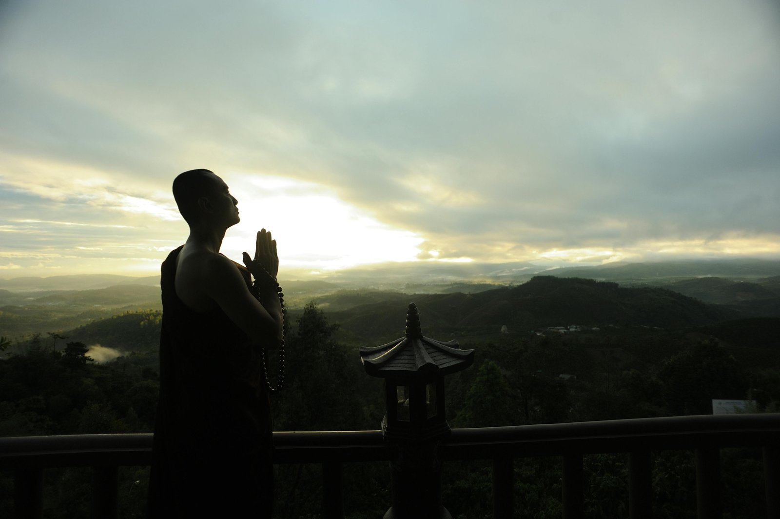 Traveler praying outdoors seeking spiritual guidance and protection during a peaceful journey