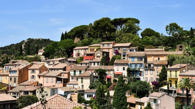 Scenic view of a peaceful southern France coastal village with blooming flowers and sunny weather in spring