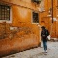 Solo traveler exploring charming European city streets with cultural landmarks and vibrant atmosphere