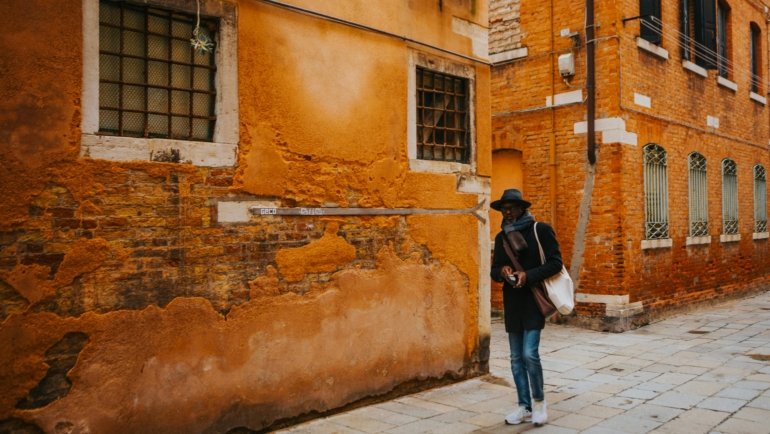 Solo traveler exploring charming European city streets with cultural landmarks and vibrant atmosphere