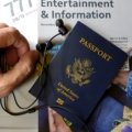 Wired noise cancelling earbuds in use by traveler on airplane for noise reduction and comfort during flight