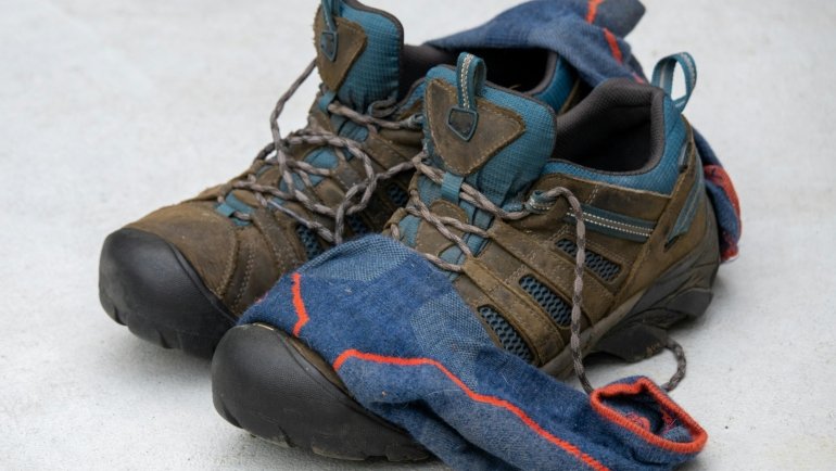 Comfortable stylish walking shoes for travel worn by a traveler on an outdoor path