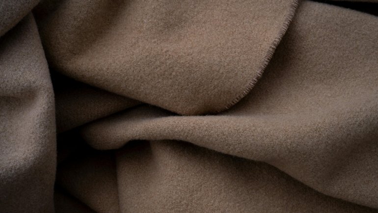 Elegant cashmere travel set with scarf, blanket, and eye mask for cozy and comfortable travel experience