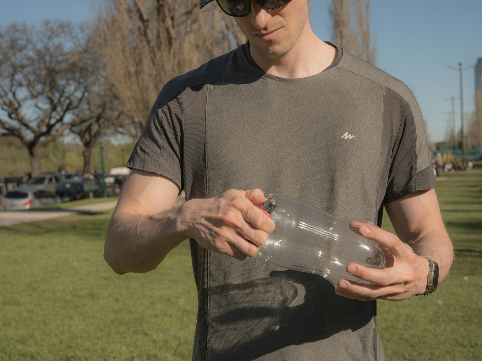 Man using a portable travel urinal outdoors during a hiking trip for convenience and hygiene