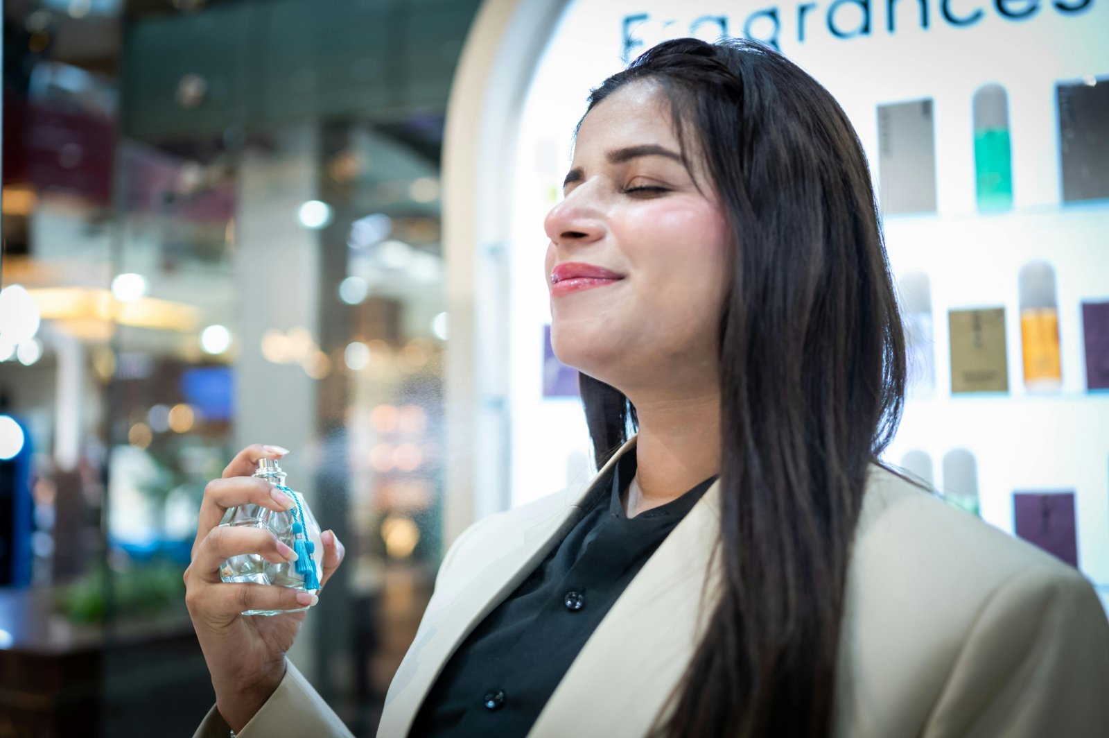 Young woman holding a compact travel perfume bottle, embodying modern and bold travel fragrance inspired by Billie Eilish