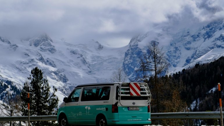 Modern Unity travel van parked in nature, perfect for road trips and van life adventures with comfortable and functional design