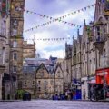 Crowd enjoying summer festival with historic Edinburgh buildings in the background