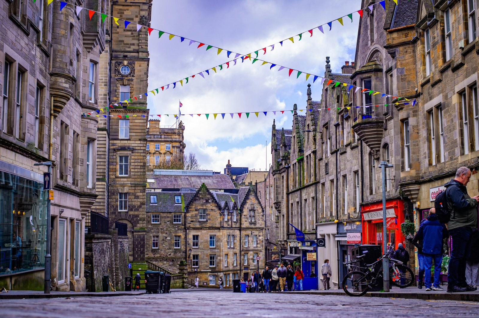 Crowd enjoying summer festival with historic Edinburgh buildings in the background