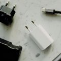 Compact travel adapter plug compatible with type C and F sockets for charging electronic devices safely in Spain