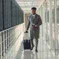 Man wearing wrinkle-resistant travel suit at airport, combining style and comfort for business travel