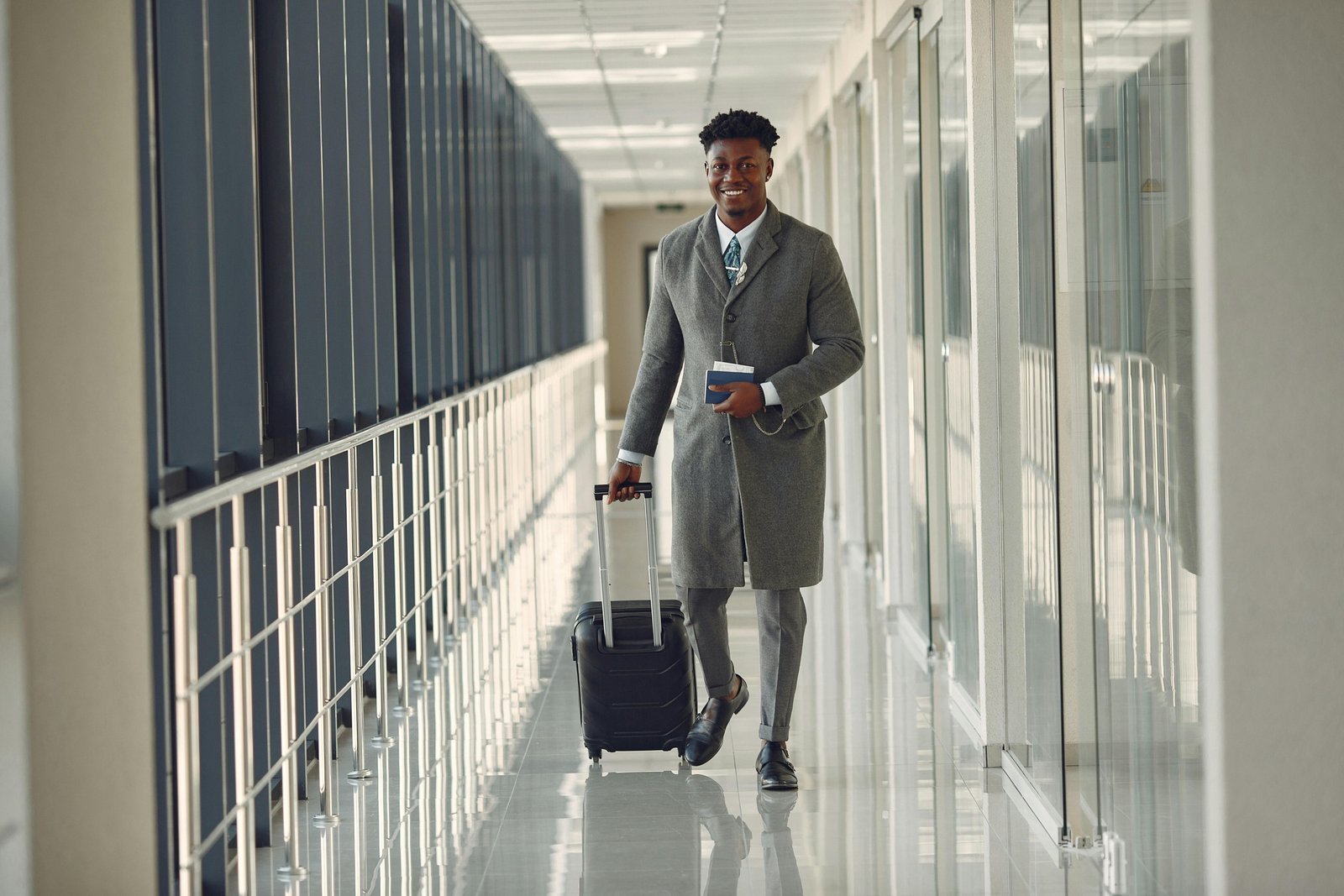Man wearing wrinkle-resistant travel suit at airport, combining style and comfort for business travel