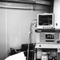 Traveling anesthesia technician setting up anesthesia equipment in hospital operating room