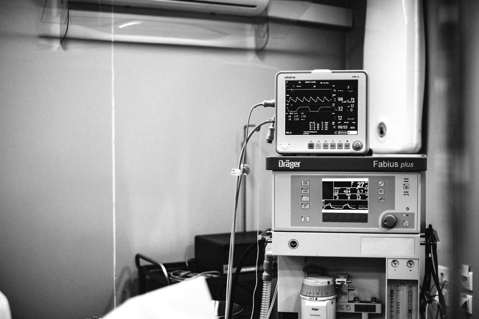 Traveling anesthesia technician setting up anesthesia equipment in hospital operating room
