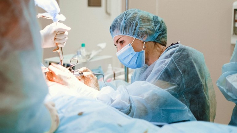 Traveling surgical technician preparing surgical instruments in hospital operating room