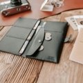 Open travel billfold showing RFID-blocking compartments with passport, credit cards, and cash organized for safe and convenient travel