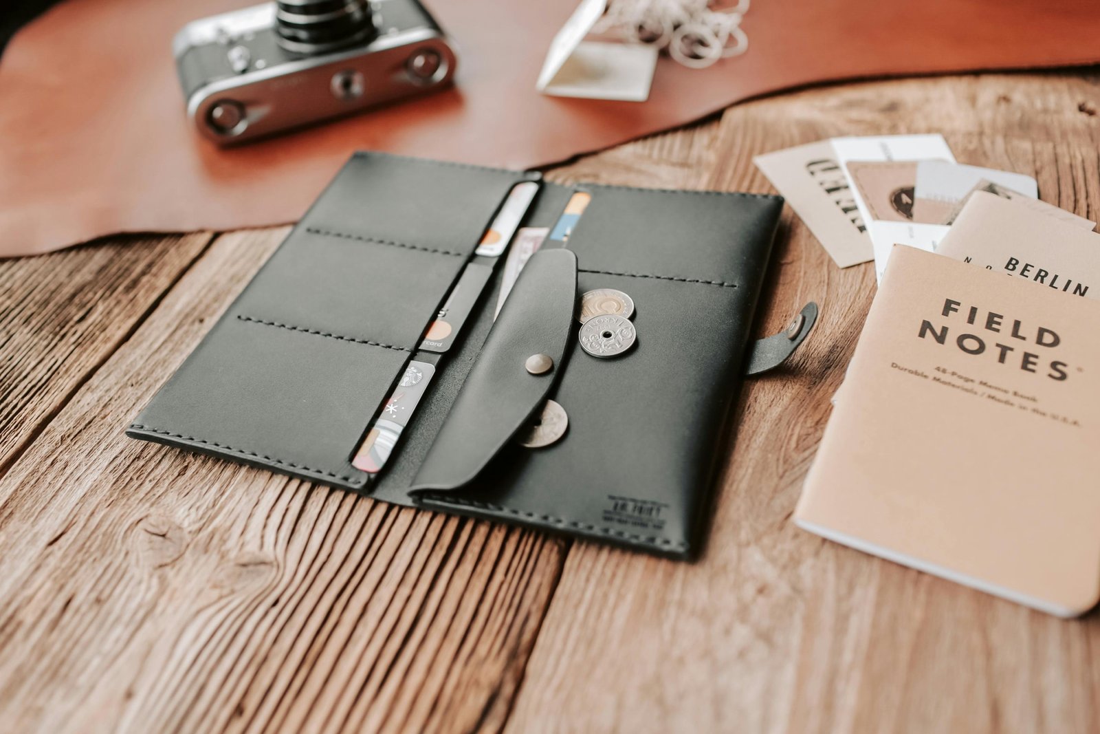 Open travel billfold showing RFID-blocking compartments with passport, credit cards, and cash organized for safe and convenient travel