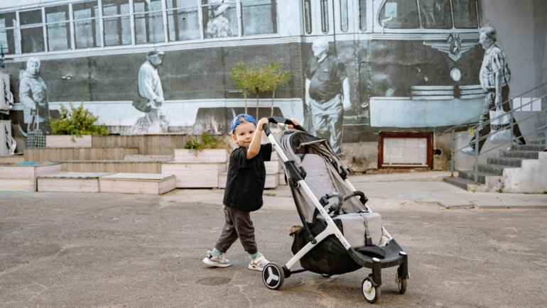 Lightweight compact travel stroller used by parents for easy transport during travel and outdoor adventures