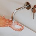 Traveler dissolving lightweight soap sheets in hands for hygienic and convenient handwashing during a trip