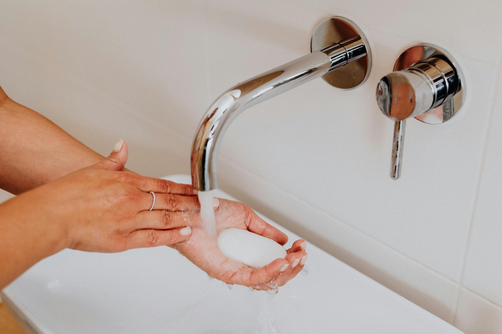 Traveler dissolving lightweight soap sheets in hands for hygienic and convenient handwashing during a trip