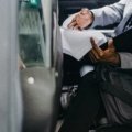 Person carefully reviewing travel documents and probation papers before traveling with official permission