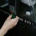 Traveler using debit card for secure payment abroad with no foreign transaction fees