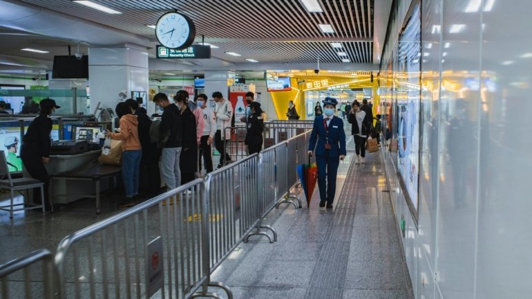 Travel security guard monitoring airport terminal ensuring passenger safety and security