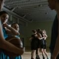 Youth basketball travel team competing in a tournament, demonstrating teamwork and skill development