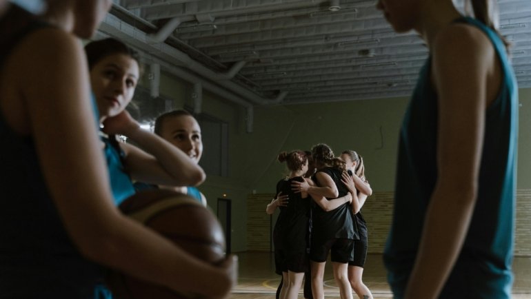 Youth basketball travel team competing in a tournament, demonstrating teamwork and skill development