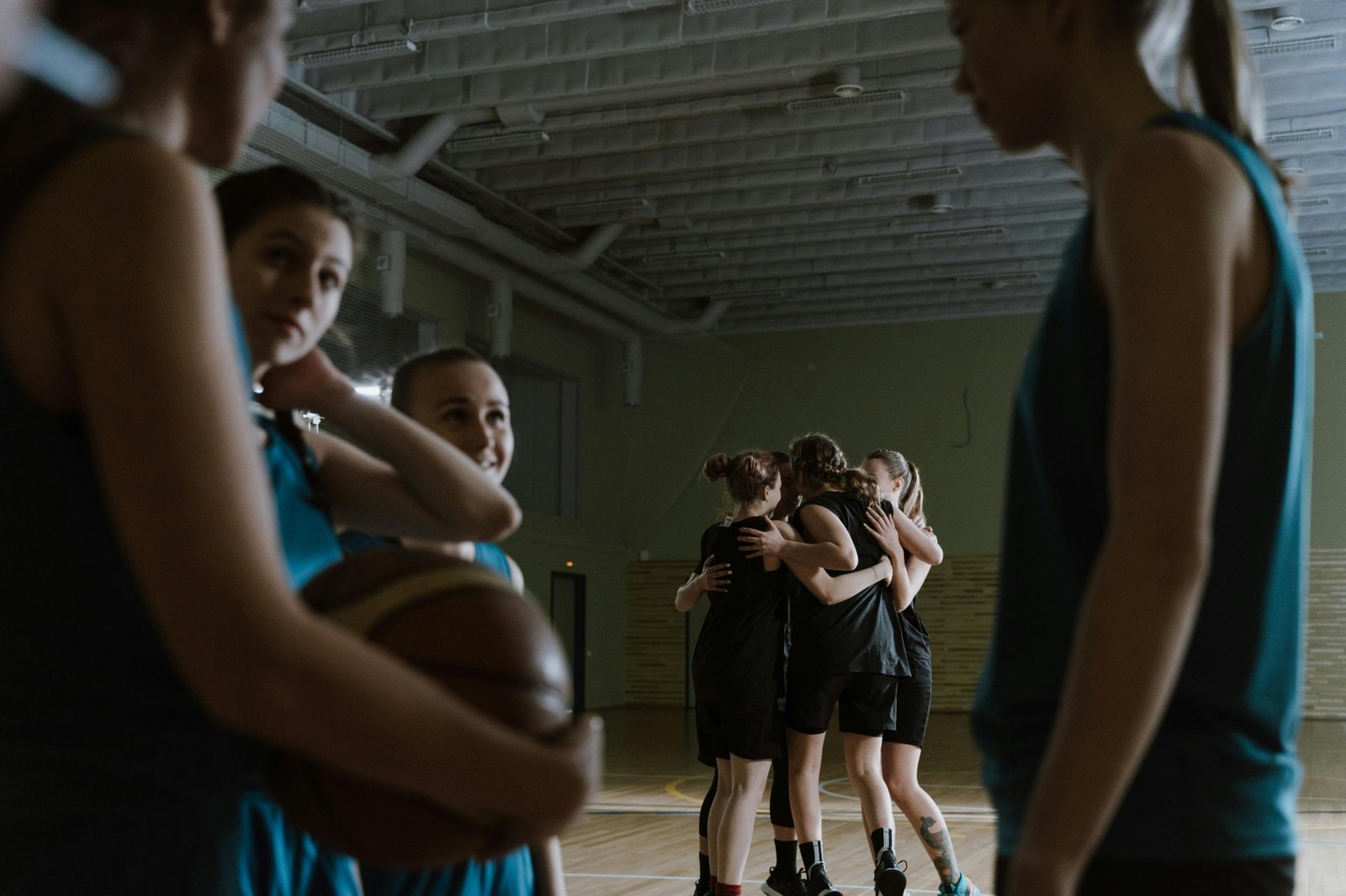 Youth basketball travel team competing in a tournament, demonstrating teamwork and skill development