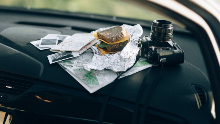 Organized car interior with travel accessories including phone mount, seat cushion, and car organizer for a comfortable and safe road trip