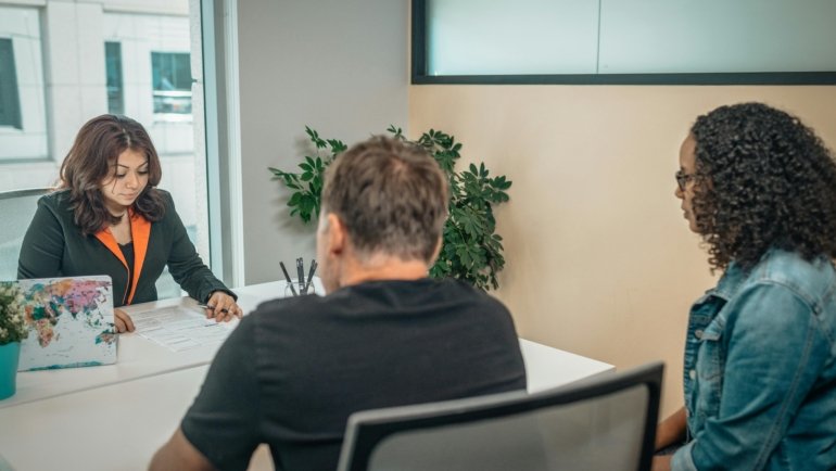 Travel agent helping clients plan personalized trips at Big D Travel Center in Irving Texas